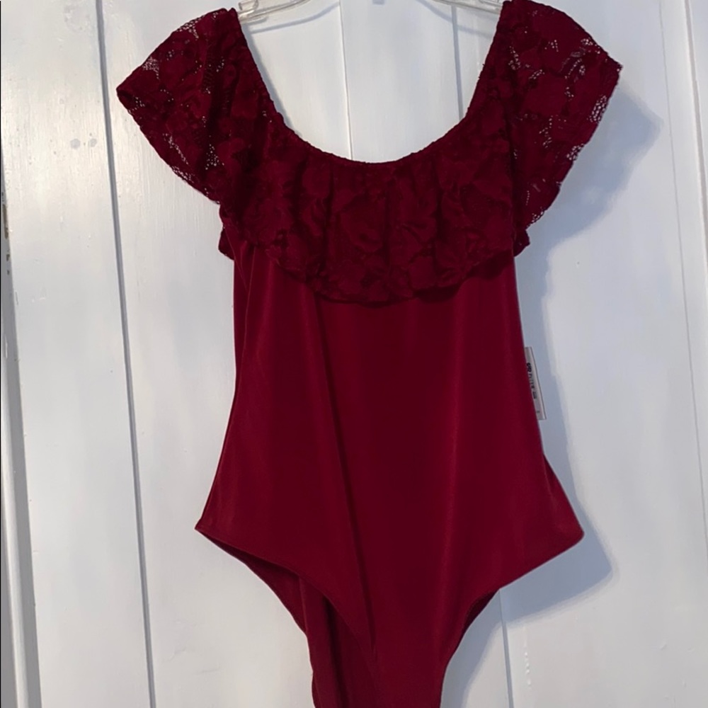 A maroon, off the shoulder body suit